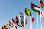 Flags of the world's nations fly at the entrance to the Expo 2020 exhibition site in Dubai.