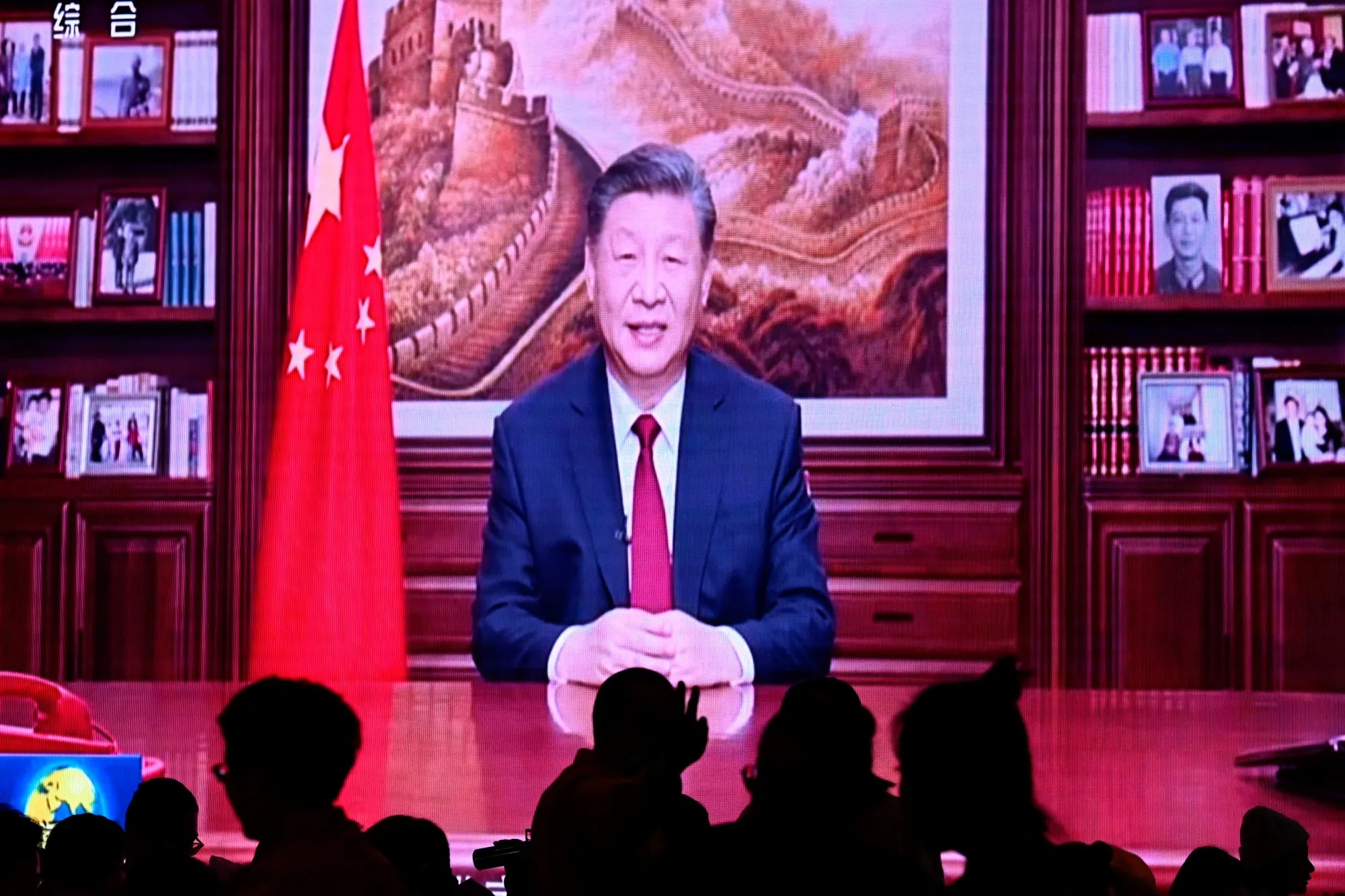 Xi Jinping’s New Year’s speech on a screen, in Beijing, on Dec. 31.