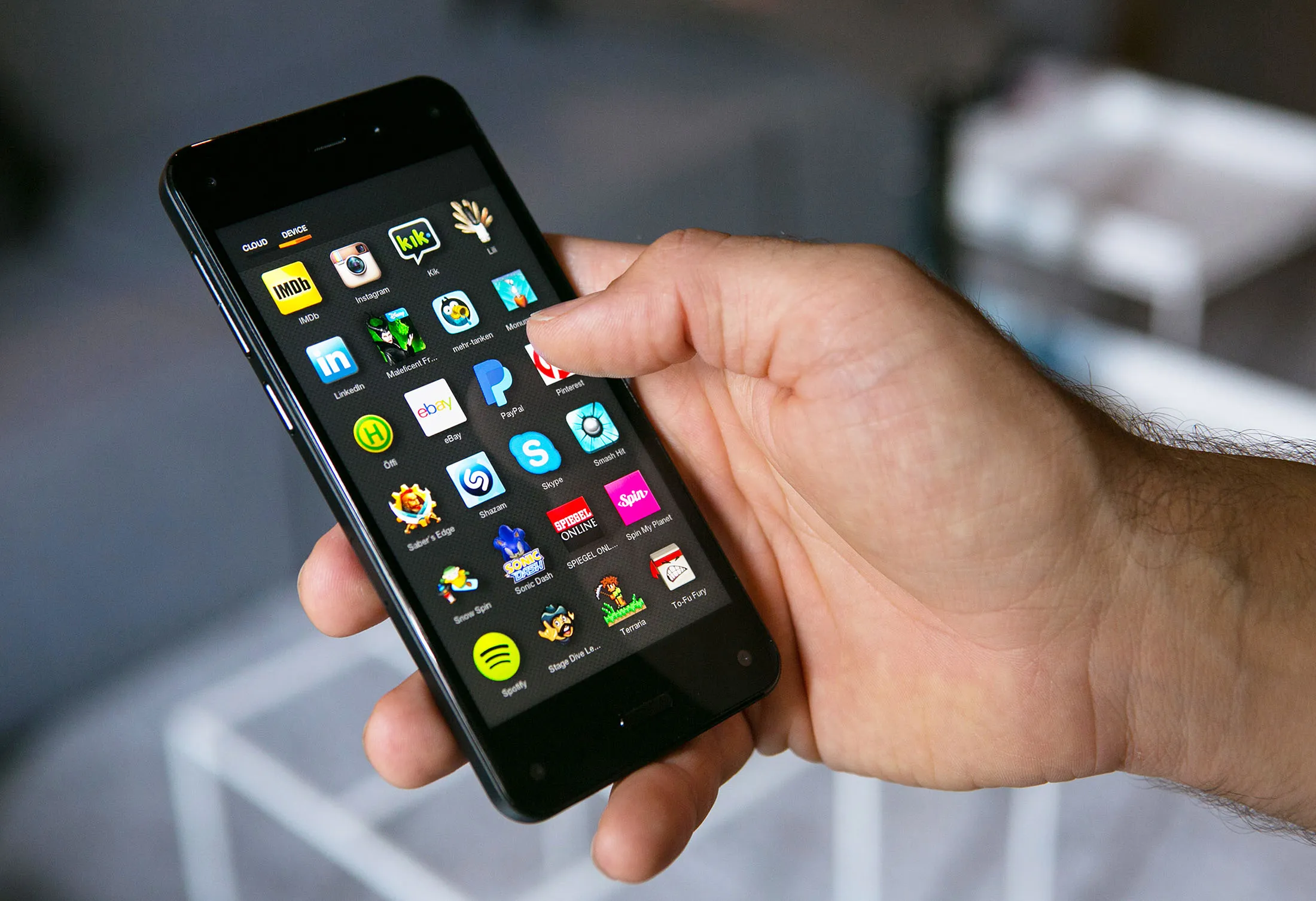 A man holds the new Fire smartphone by Amazon.com Inc.
