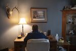 A person works from home on a laptop computer in Princeton, Illinois.