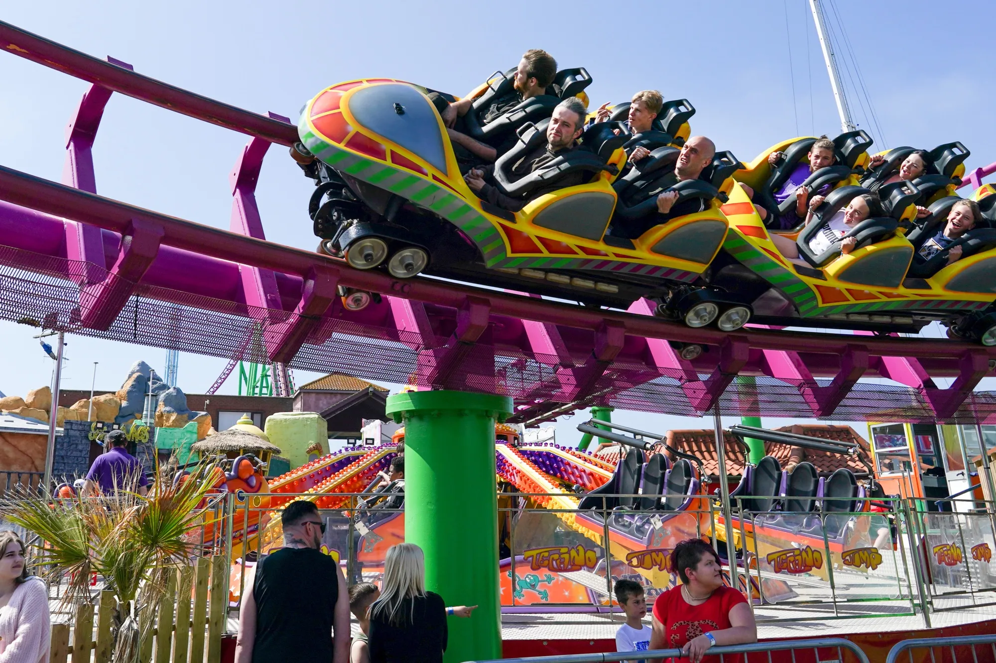 Enjoying the ups and downs: Visitors queue as a rollercoaster passes overhead at the Fantasy Island theme park in Skegness, UK, on Monday, May 31, 2021 .