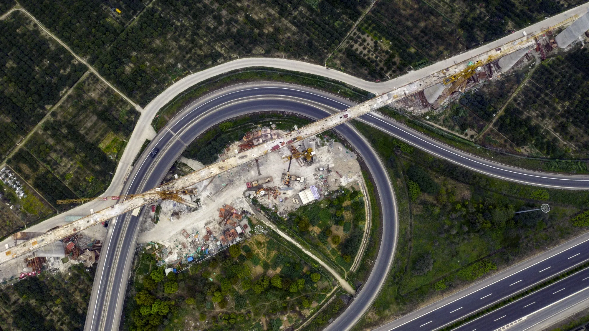 Highways run next to an under construction section of an elevated track for the China State Railway Group Co. High-speed (CRH) railway system in&nbsp; in Taizhou, China.