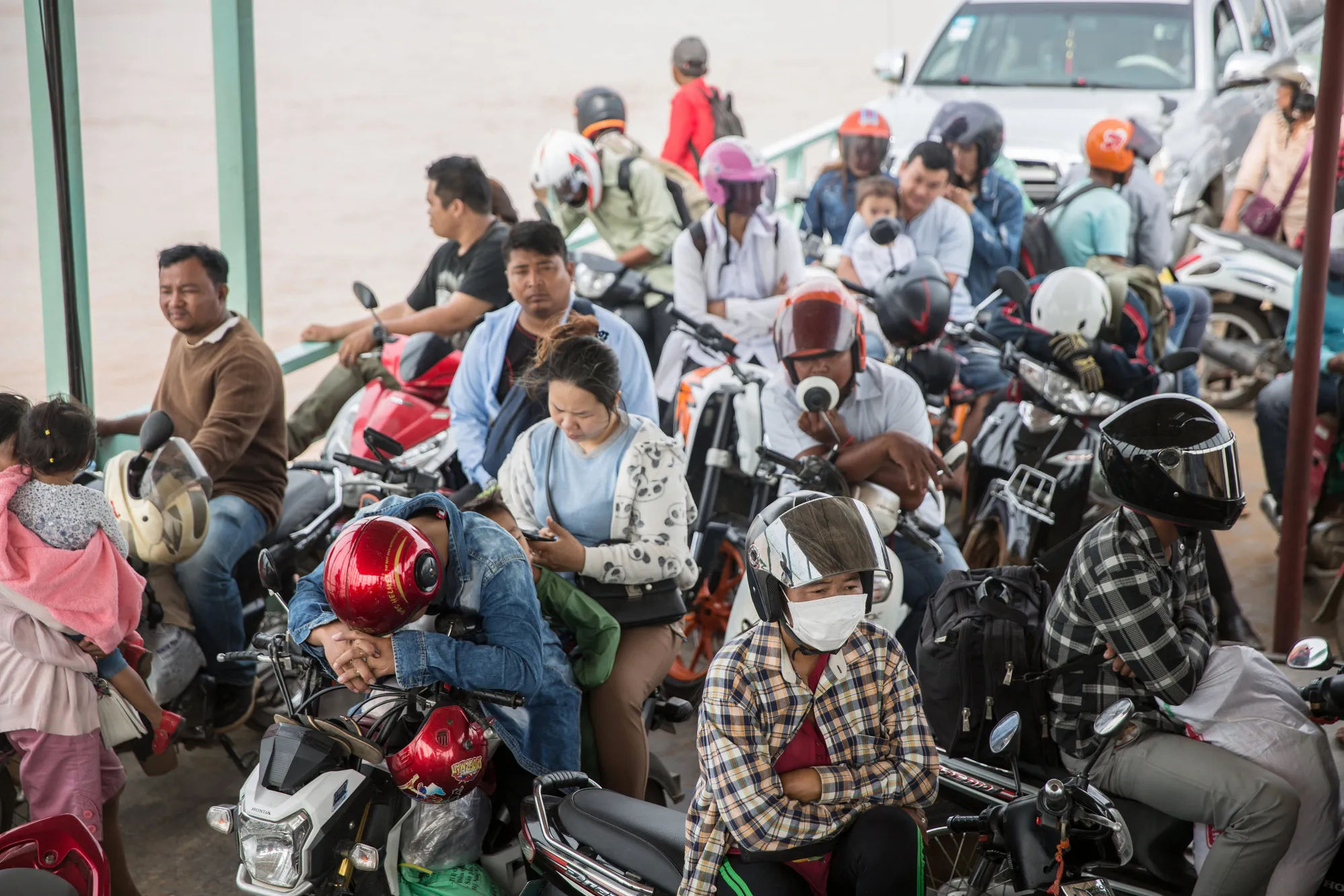 Commuters ride a ferry across the Mekong River towards Phnom Penh.