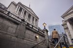 A morning commuter passes the Bank of England in London. 
