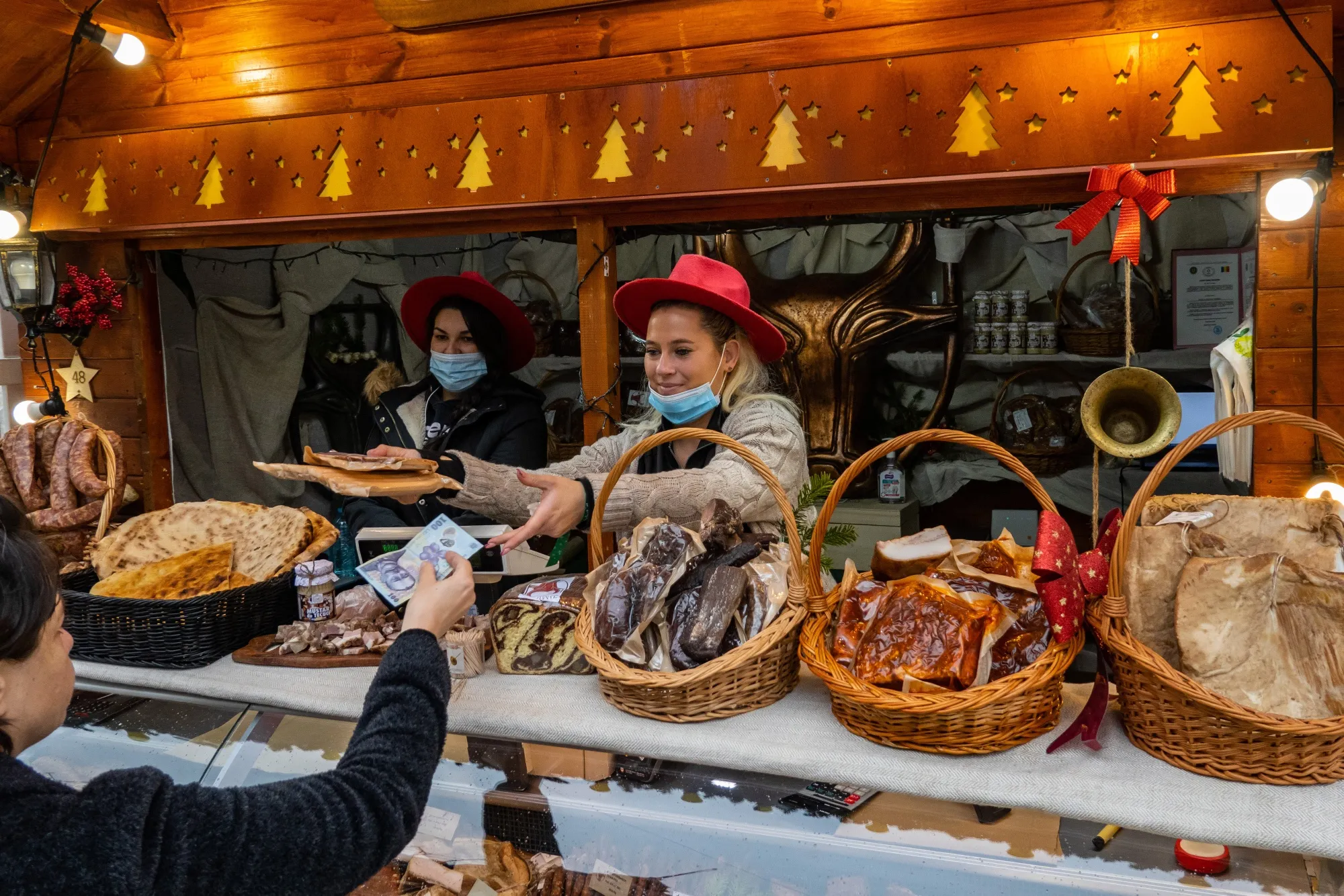 A customer hands over a leu banknote at a market in Bucharest.