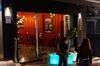 Staffs wait for customers outside an empty restaurant in the Central district in Hong Kong, China, on Friday, Nov. 27, 2020. Hong Kong shuttered bars, nightclubs and bathhouses from Thursday until Dec. 2 as concerns rise about a new wave of Covid-19 cases in the Asian financial hub.