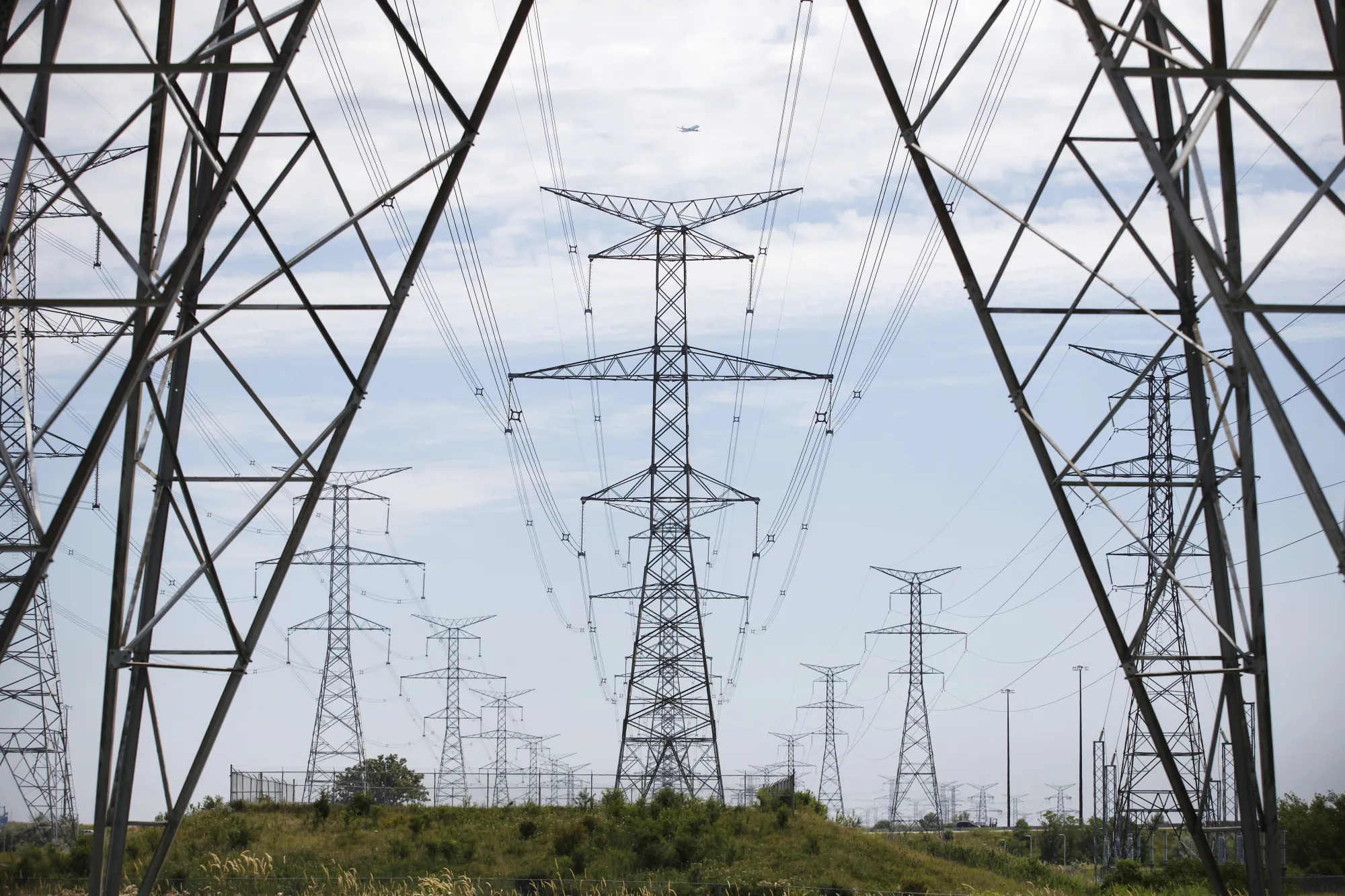 Power lines run through transmission towers in Toronto, Ontario.