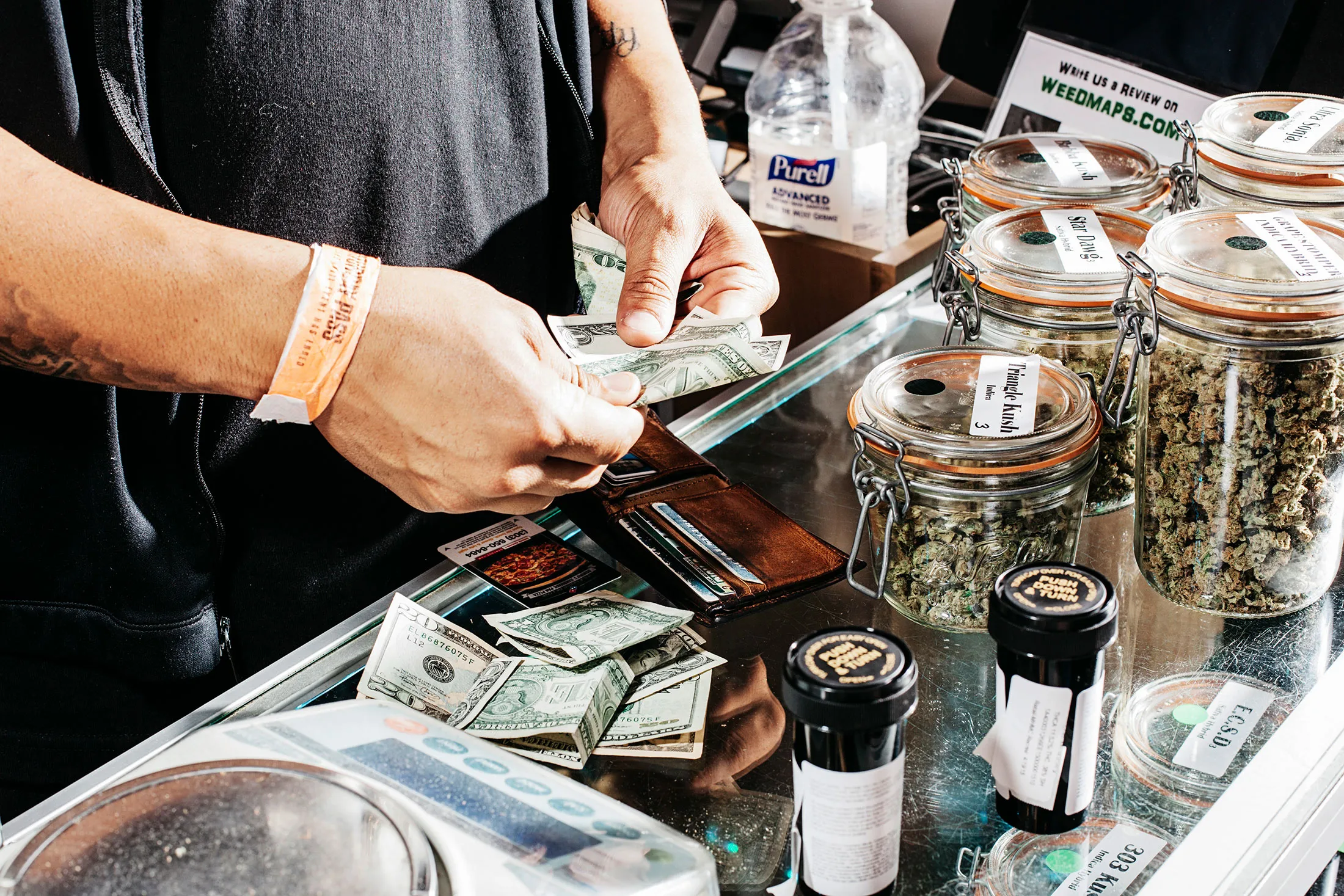 A customer pays for his marijuana purchase at a shop in Denver.

