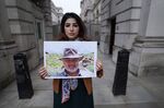 Roxanne Tahbaz holds a picture of her father Morad Tahbaz in London in April.