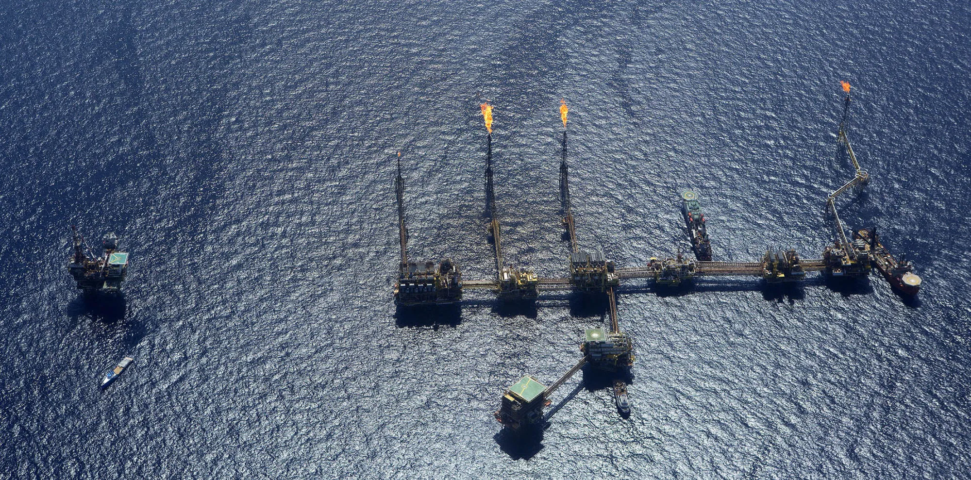 Gas is flared from towers on an oil drilling rig in the Ku-Maloob-Zaap oilfield at Campeche Bay off the coast of Ciudad del Carmen, Mexico.
