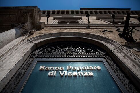 A logo is displayed on the window of a Banca Popolare di Vicenza SpA bank branch in Rome, Italy, on Monday, June 26, 2017. Italy orchestrated its biggest bank rescue on record, committing as much as 17 billion euros ($19 billion) to clean up two failed banks in one of its wealthiest regions, a deal that raises questions about the consistency of Europe’s bank regulations. Photographer: Alessia Pierdomenico/Bloomberg
