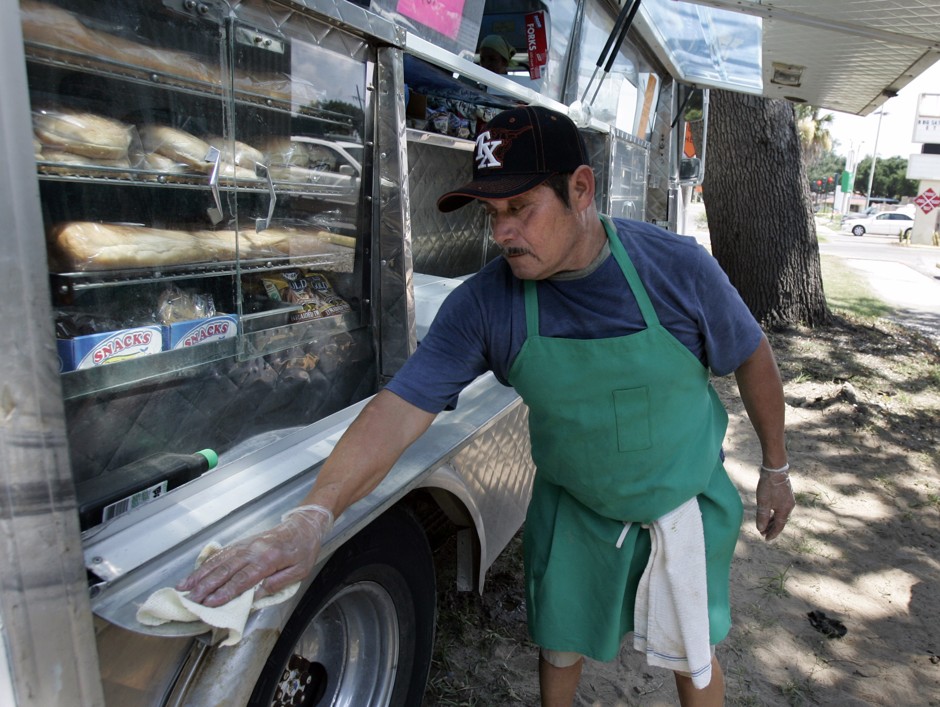 A great many Latino immigrants came to New Orleans after Hurricane Katrina (above, Pedro Ryes works at a lunch truck in June 2007). A new policy aims to ease the tension between these new arrivals to the city and local police.