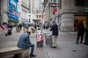 Pedestrians use their smartphones near the New York Stock Exchange (NYSE) in New York, U.S., on Friday, June 14, 2019. PetSmart Inc.-controlled Chewy Inc. surged in its first day of trading after raising $1.02 billion in an initial public offering, as investors bet that pet owners will do more of their shopping online for everything from cat food to doggy sweaters.