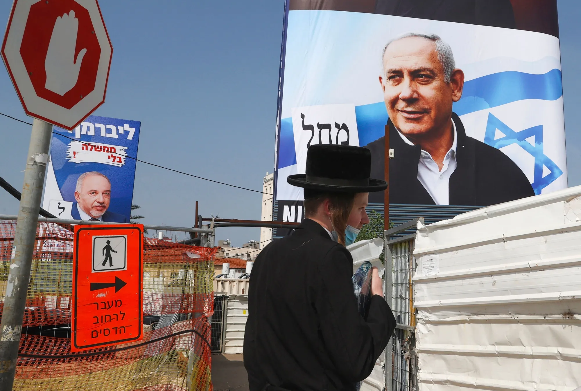 Election campaign posters of Avigdor Liberman, left, and&nbsp;Benjamin Netanyahu in Bnei Brak, on March 14.