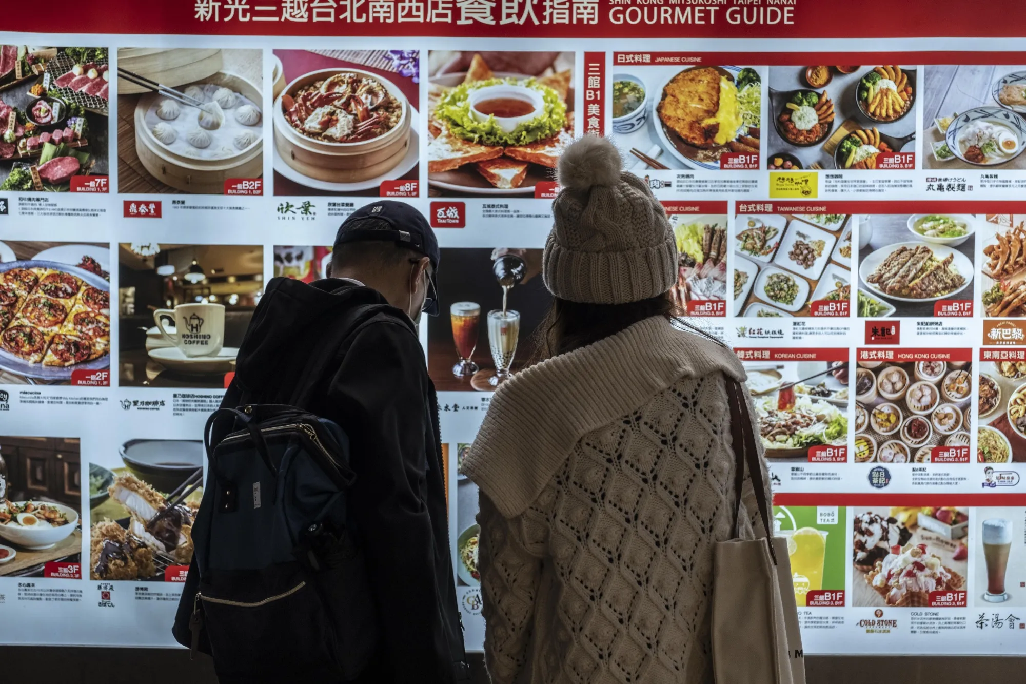 Customers look at a restaurant menu in Taipei, Taiwan.