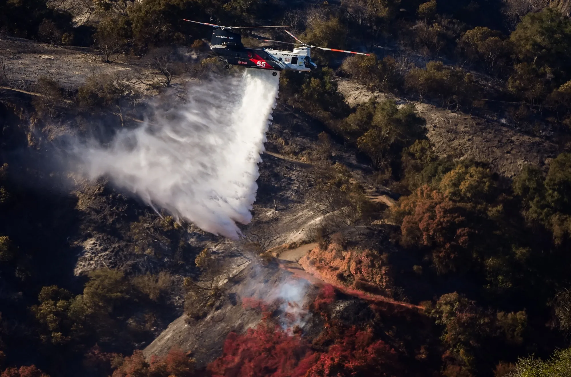 A firefighting helicopter drops water on hotspots during the Palisades Fire in Los Angeles, California,&nbsp;on&nbsp;Jan. 12.