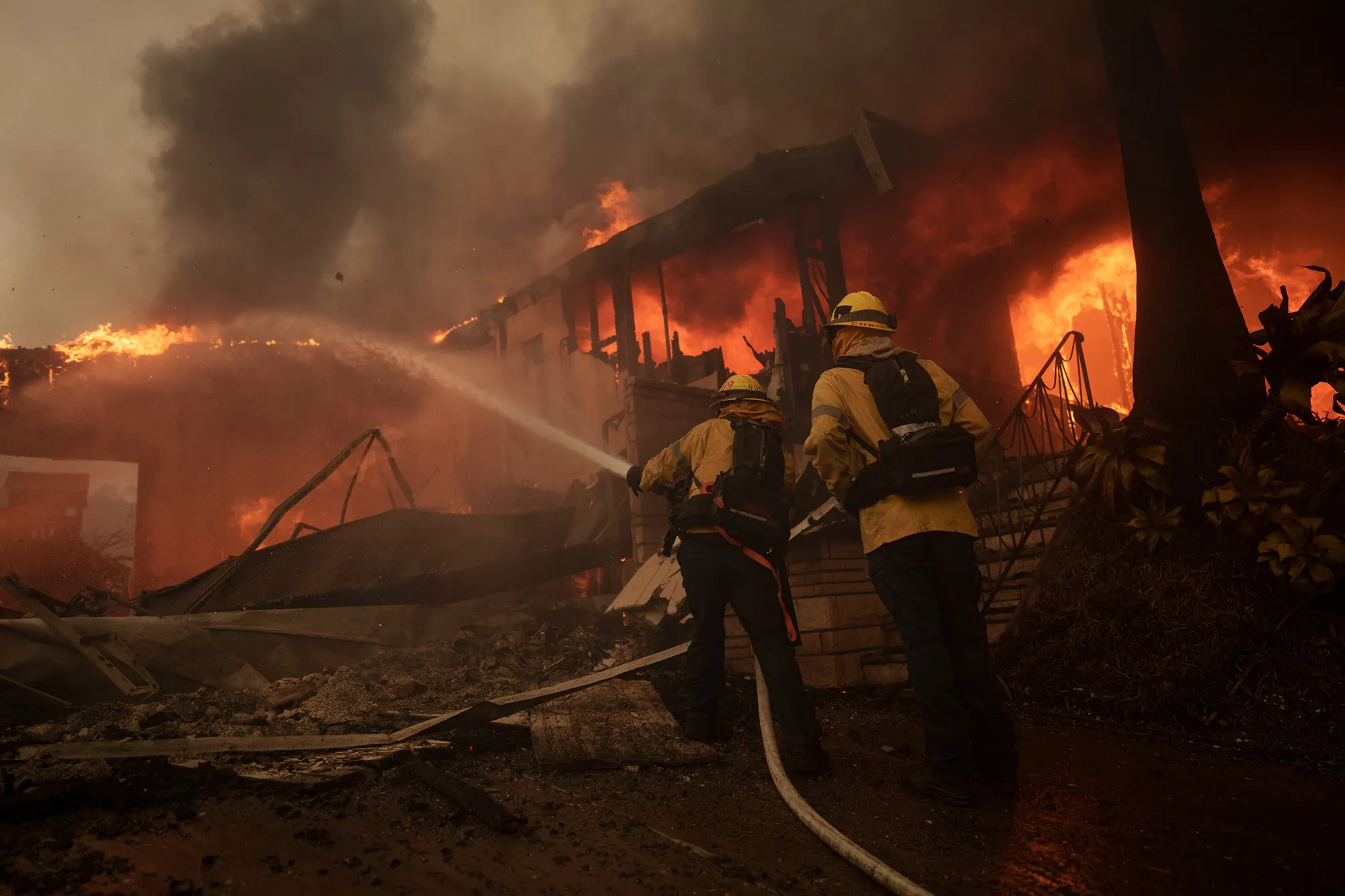 Firefighters battle flames in the Pacific Palisades neighborhood of Los Angeles.