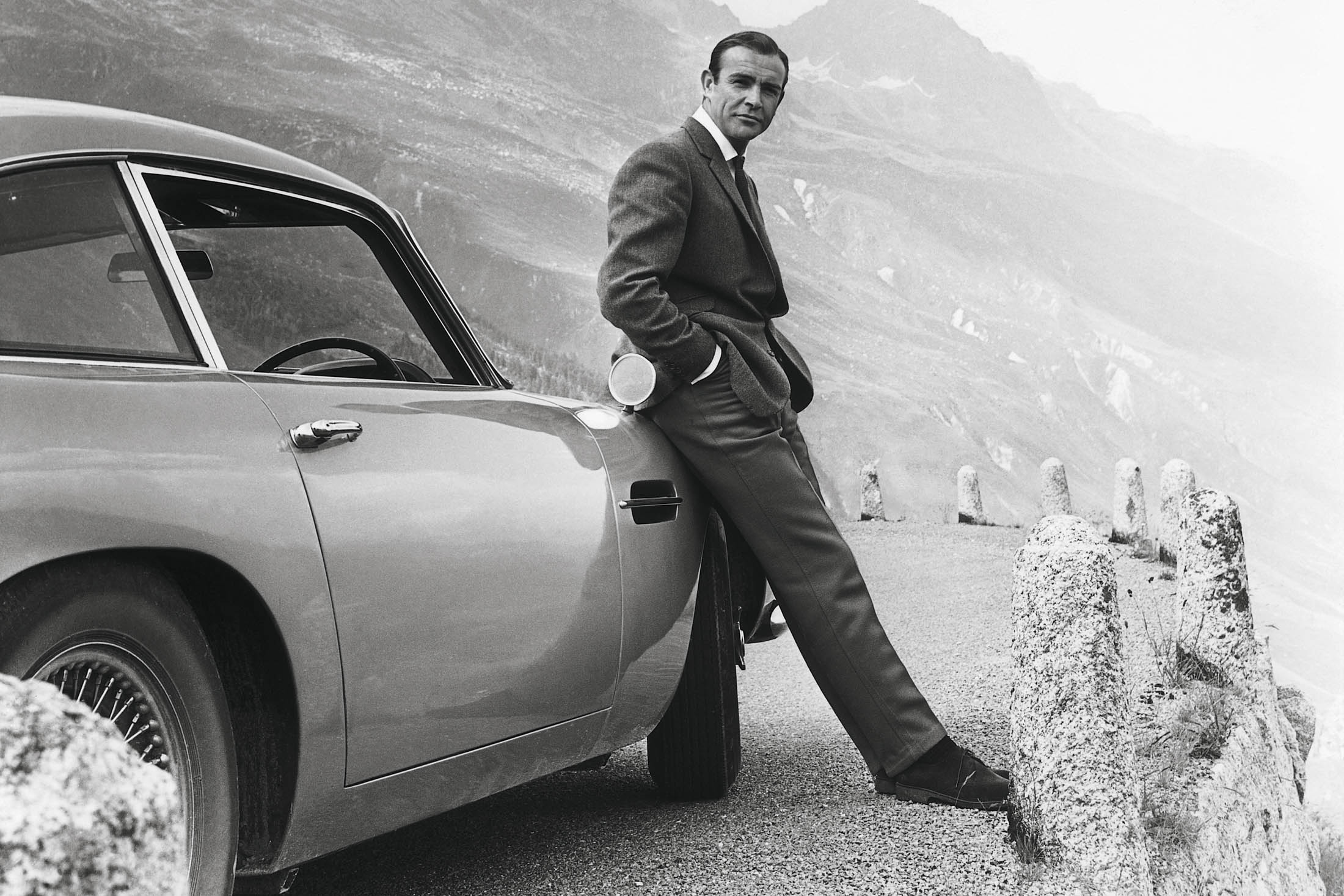 Sean Connery as James Bond, with an Aston Martin DB5.
