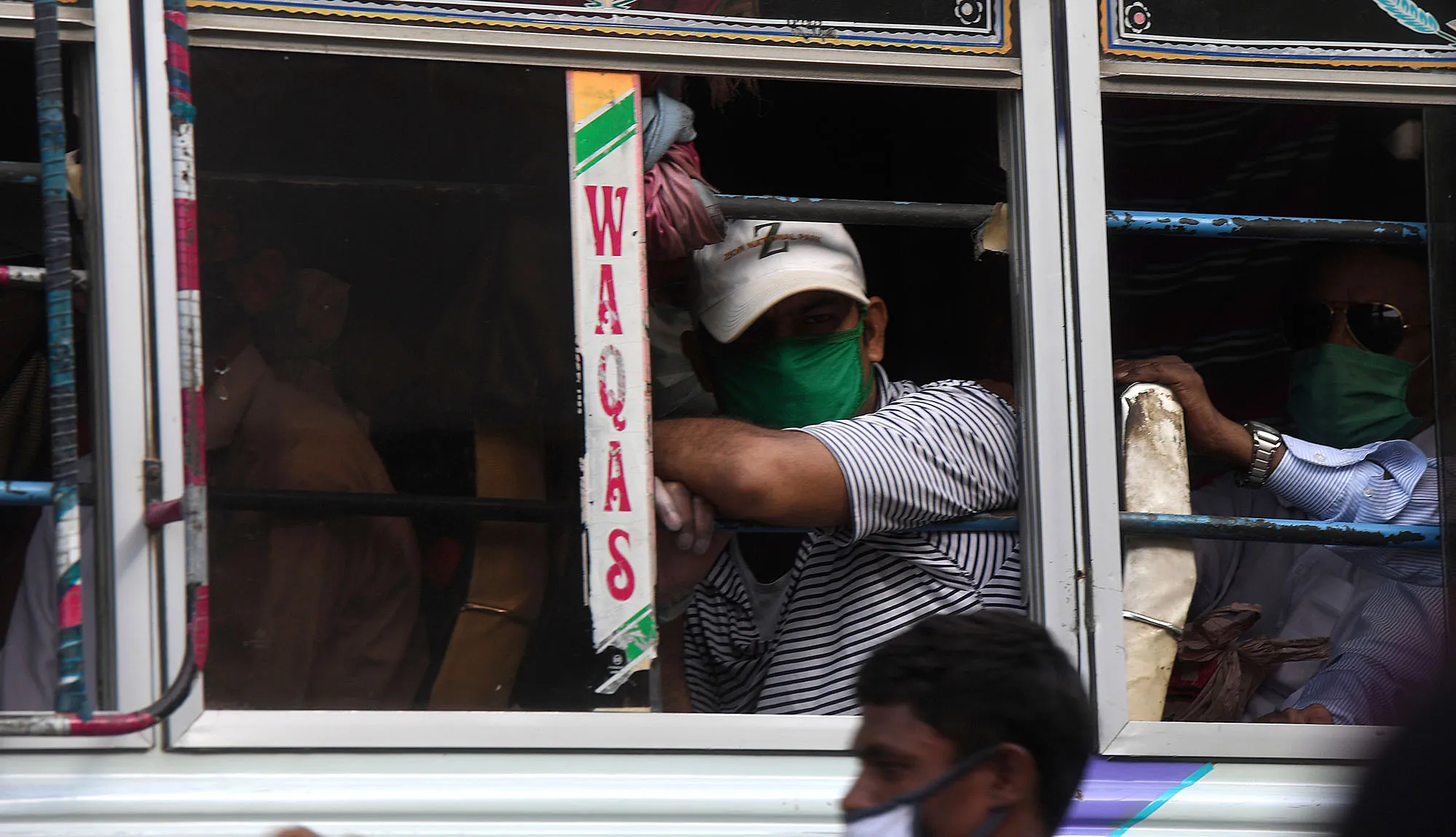 Passengers wear face masks&nbsp;on a bus in Karachi on June 8.