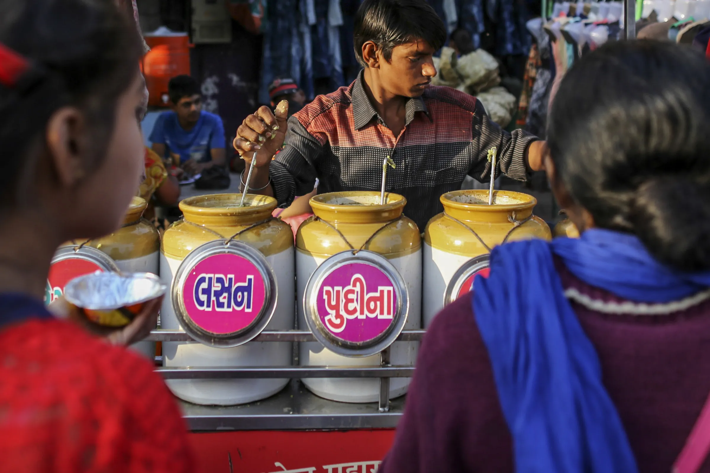 A street food vendor prepares panipuri snacks at a market stall in Ahmedabad, India.
