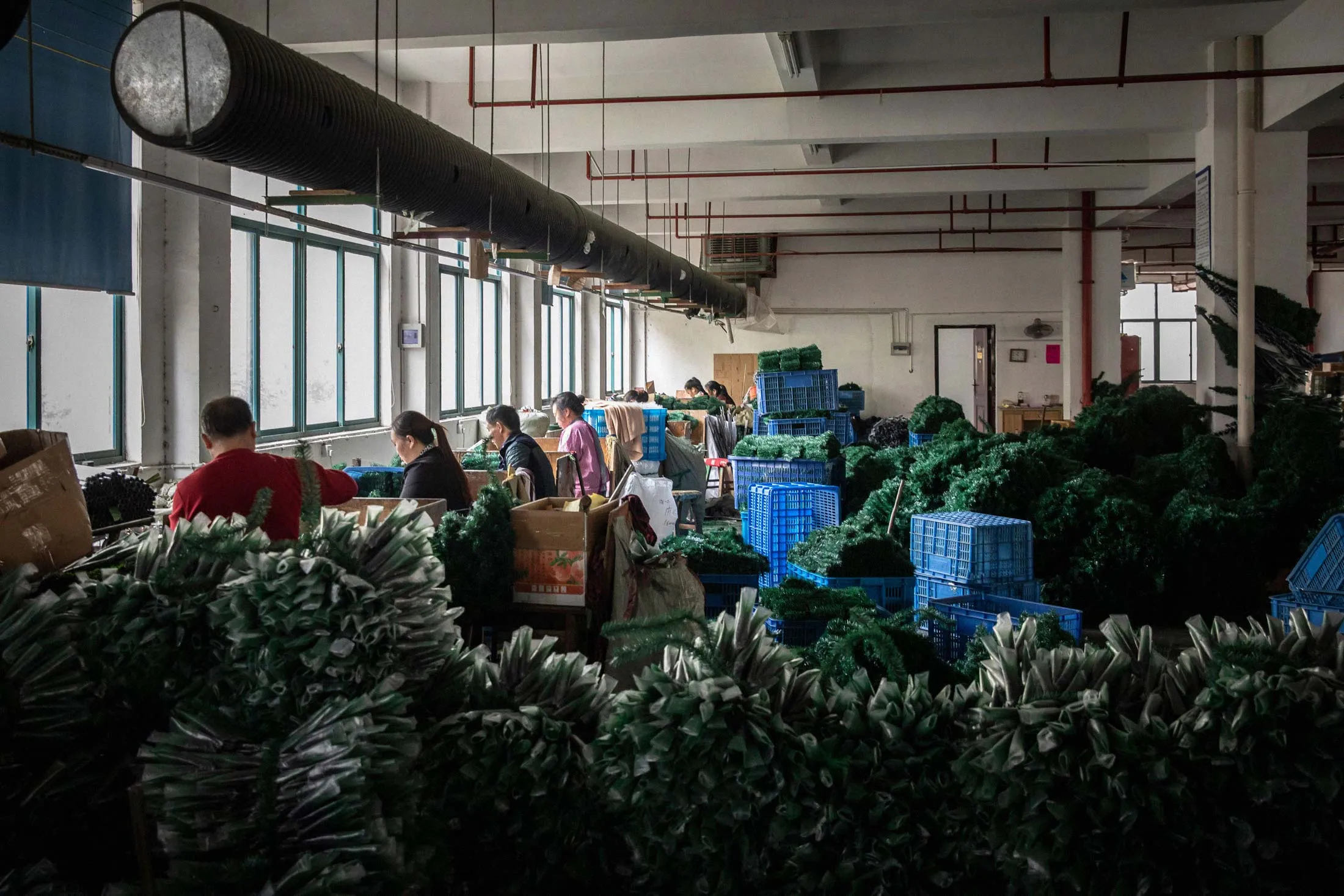 Employees make branches for artificial trees at Bosen Crafts’ factory in Yiwu.