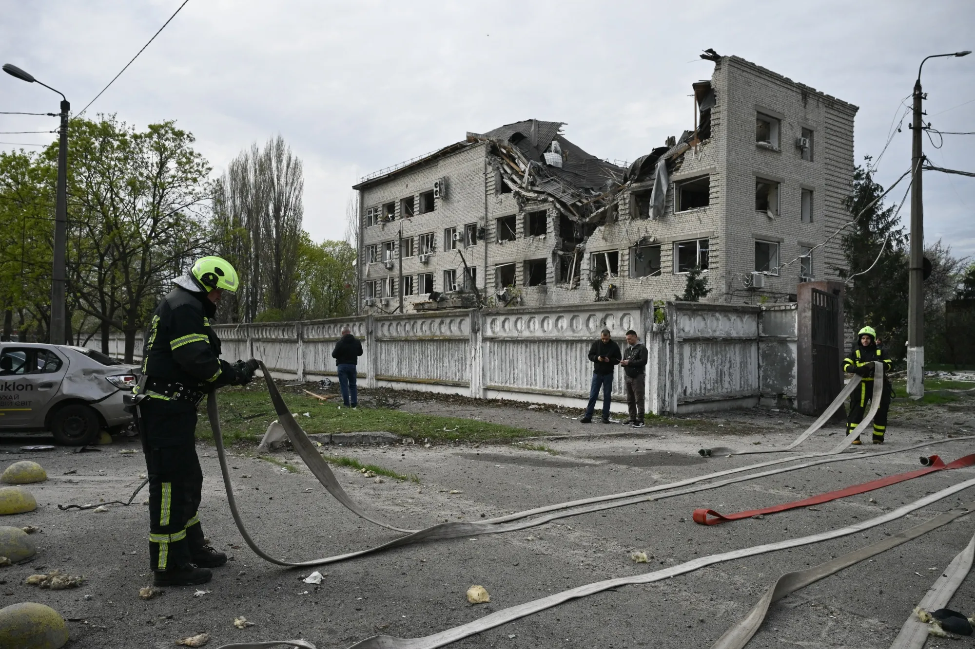 Firefighters work at a site following a Russian strike in Kyiv on April 16.