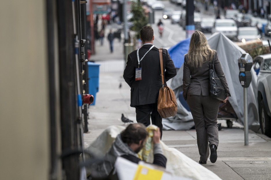 Affluence and poverty share the sidewalk on the streets of cities like San Francisco.