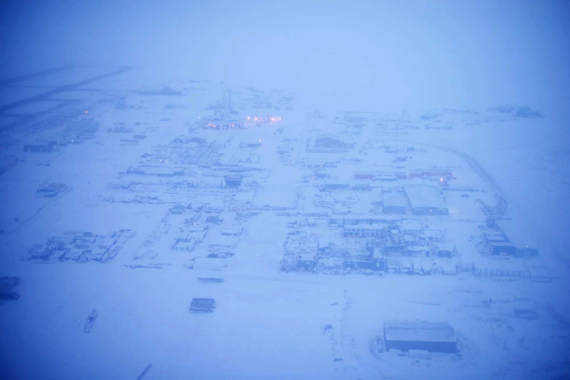 The industrial camp and base for the North Slope oil-producing community of Deadhorse, Alaska, covered in snow and ice, pictured from the air in March 2018.