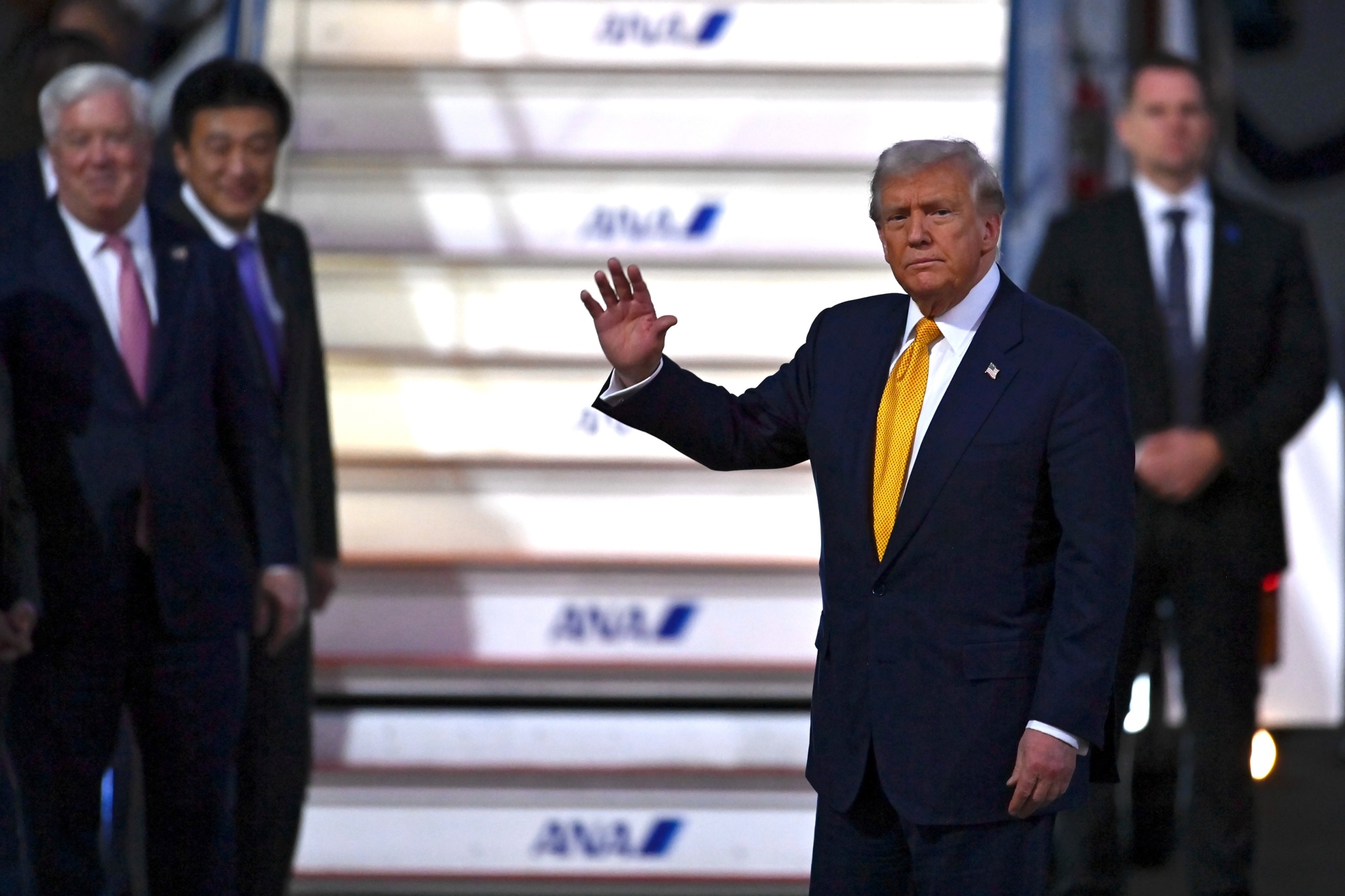 US President Donald Trump waves upon disembarking Air Force One at Haneda Airport in Tokyo, Japan, on Monday, Oct. 27, 2025. Trump arrived in Japan Monday, telling reporters he was excited for his meeting with new Japanese Prime Minister Sanae Takaichi and the prospect of completing a joint deal to promote shipbuilding capacity. Photographer: David Mareuil&#x2F;Anadolu Agency&#x2F;Bloomberg