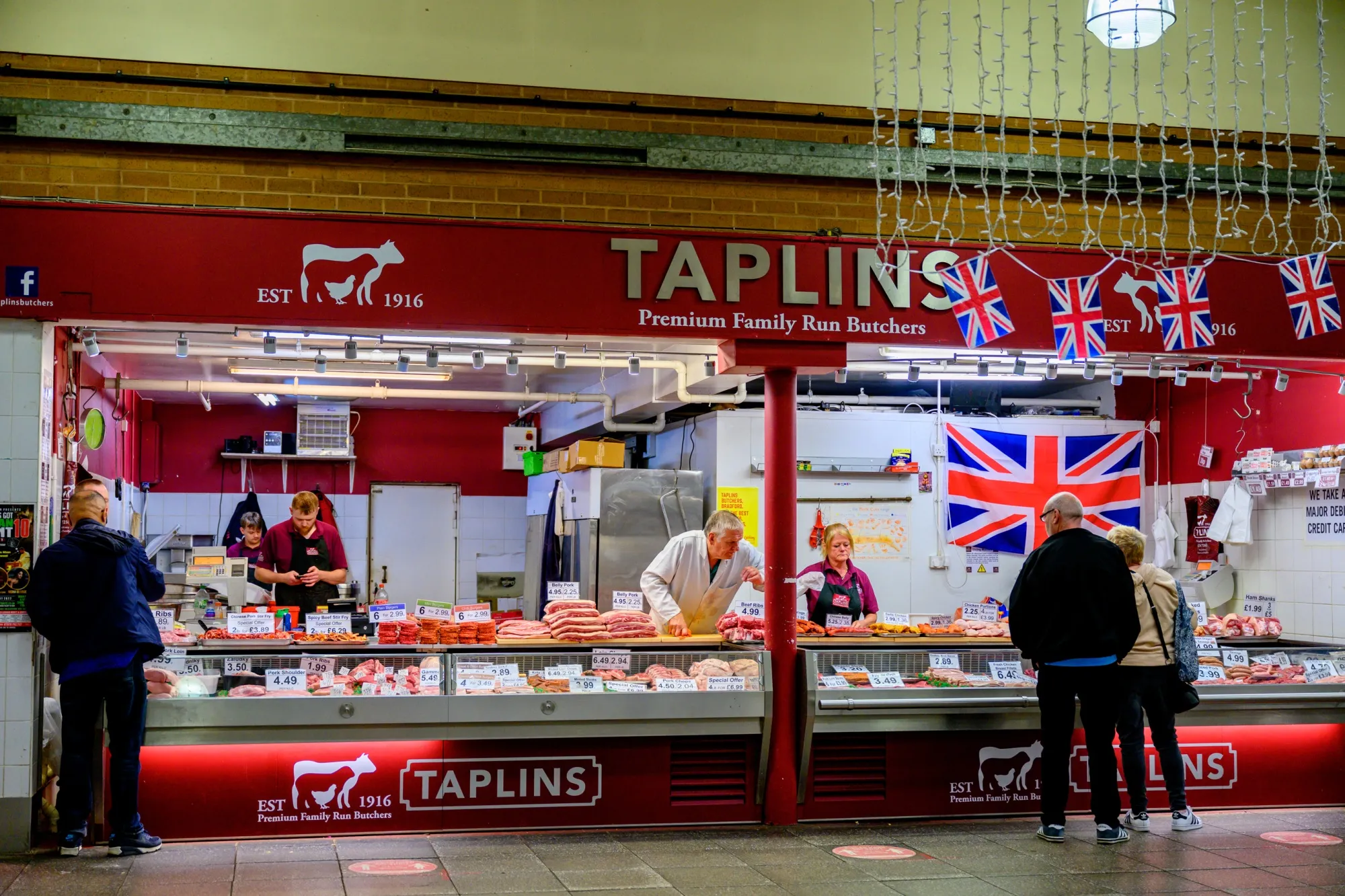 Shoppers in a covered market in Bradford, UK.