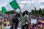 A Nigerian youth seen waving the&nbsp;national flag in support of the ongoing protest against police&nbsp;brutality.