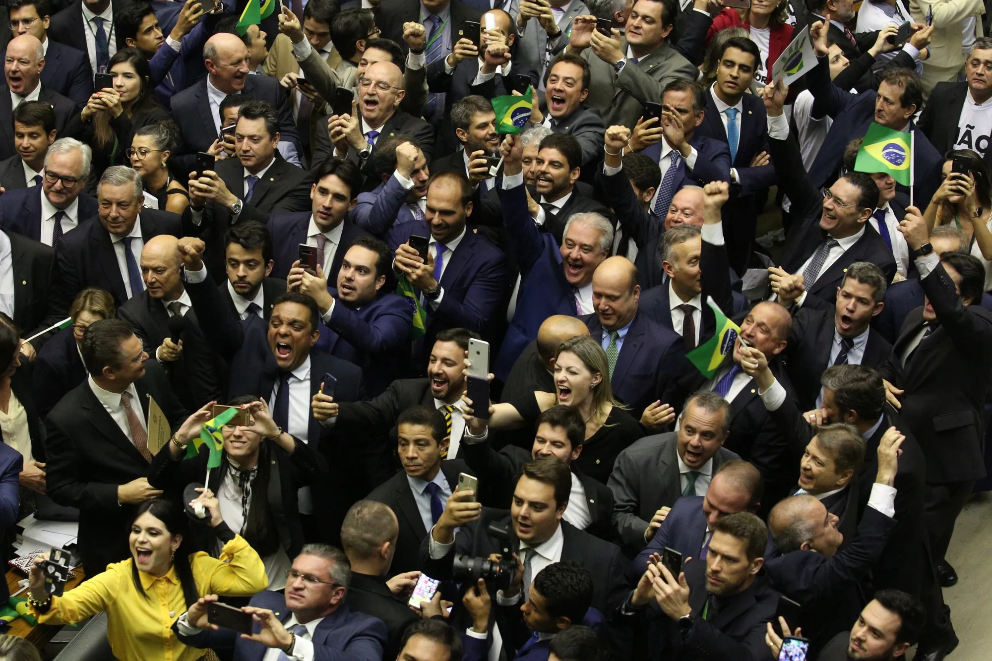 Lawmakers supporting the pension reform bill celebrate on Wednesday.