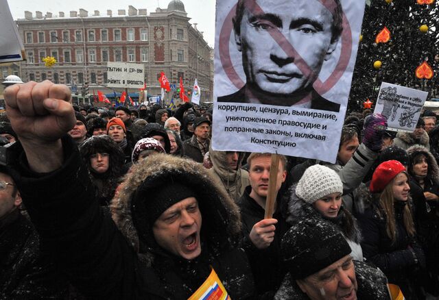 A protester carries a poster depicting Vladimir Putin during a protest rally against the alleged rigging of parliamentary elections in St. Petersburg in Dec. 2011.