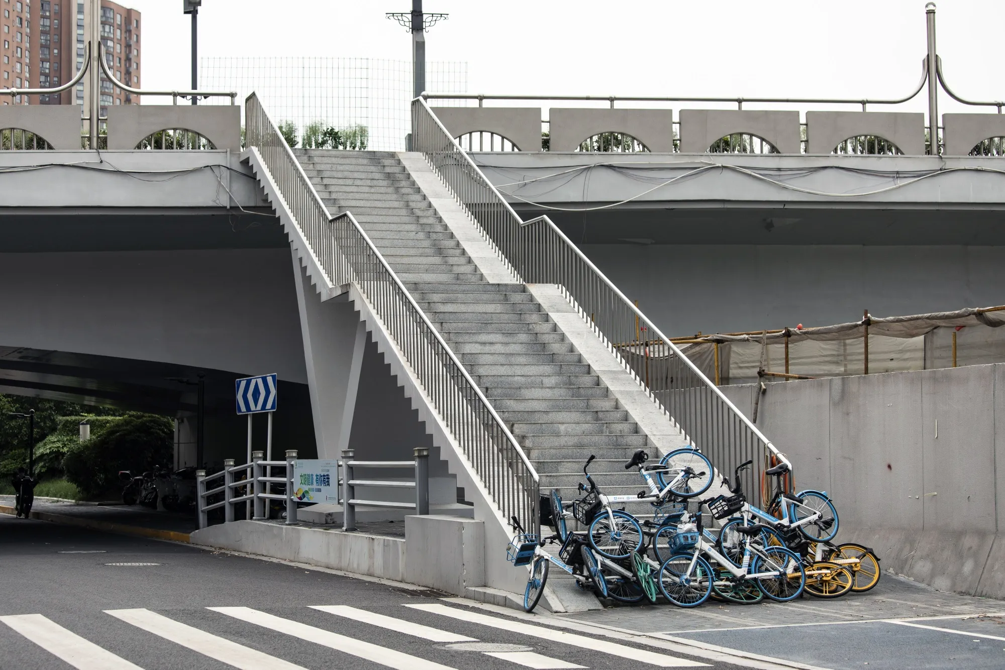 Shared bicycles form a temporary barricade at an entrance to a bridge during a lockdown in Shanghai.