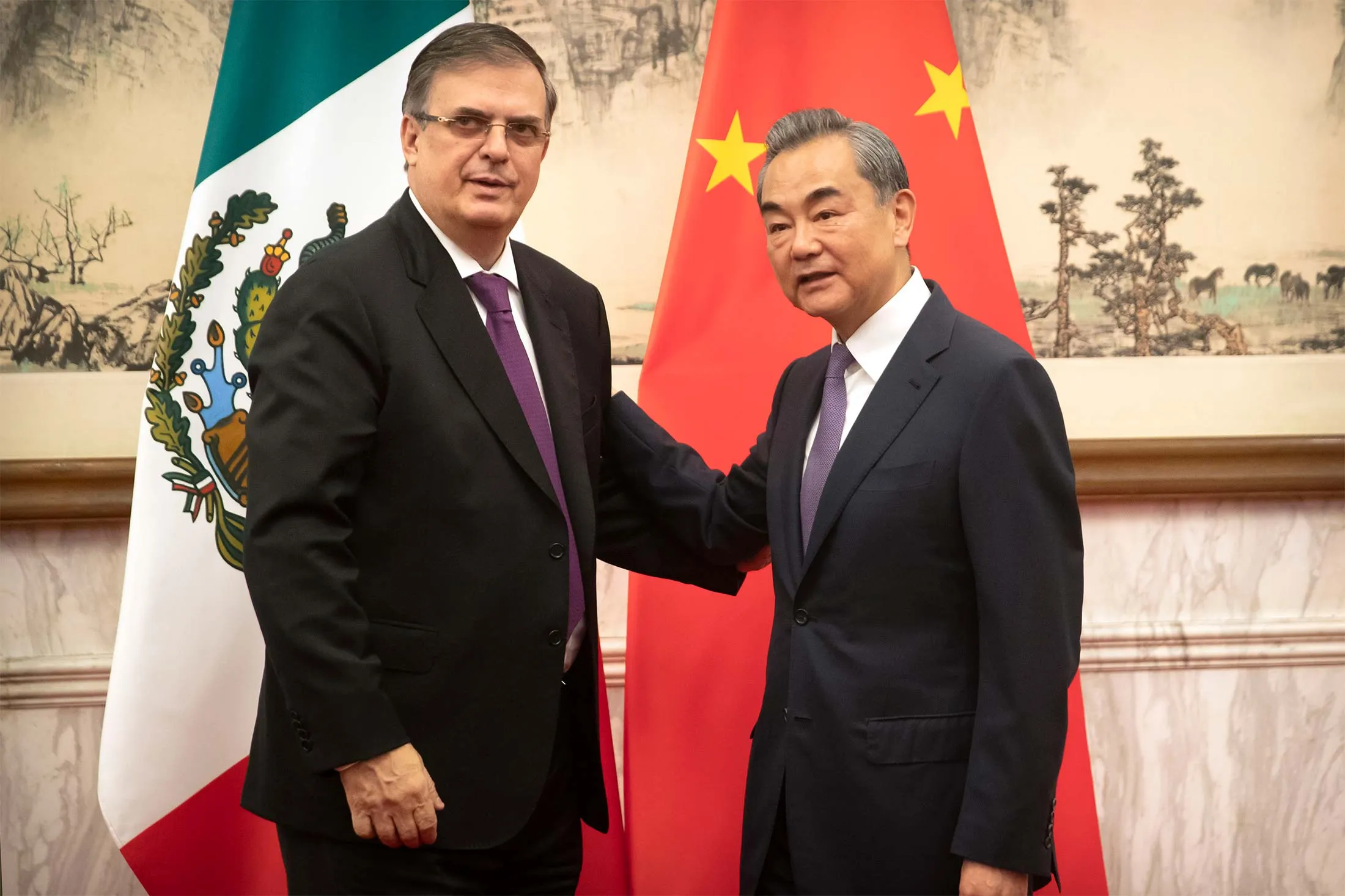 Marcelo Ebrard, left, shakes hands with Wang Yi in Beijing on July 2. 