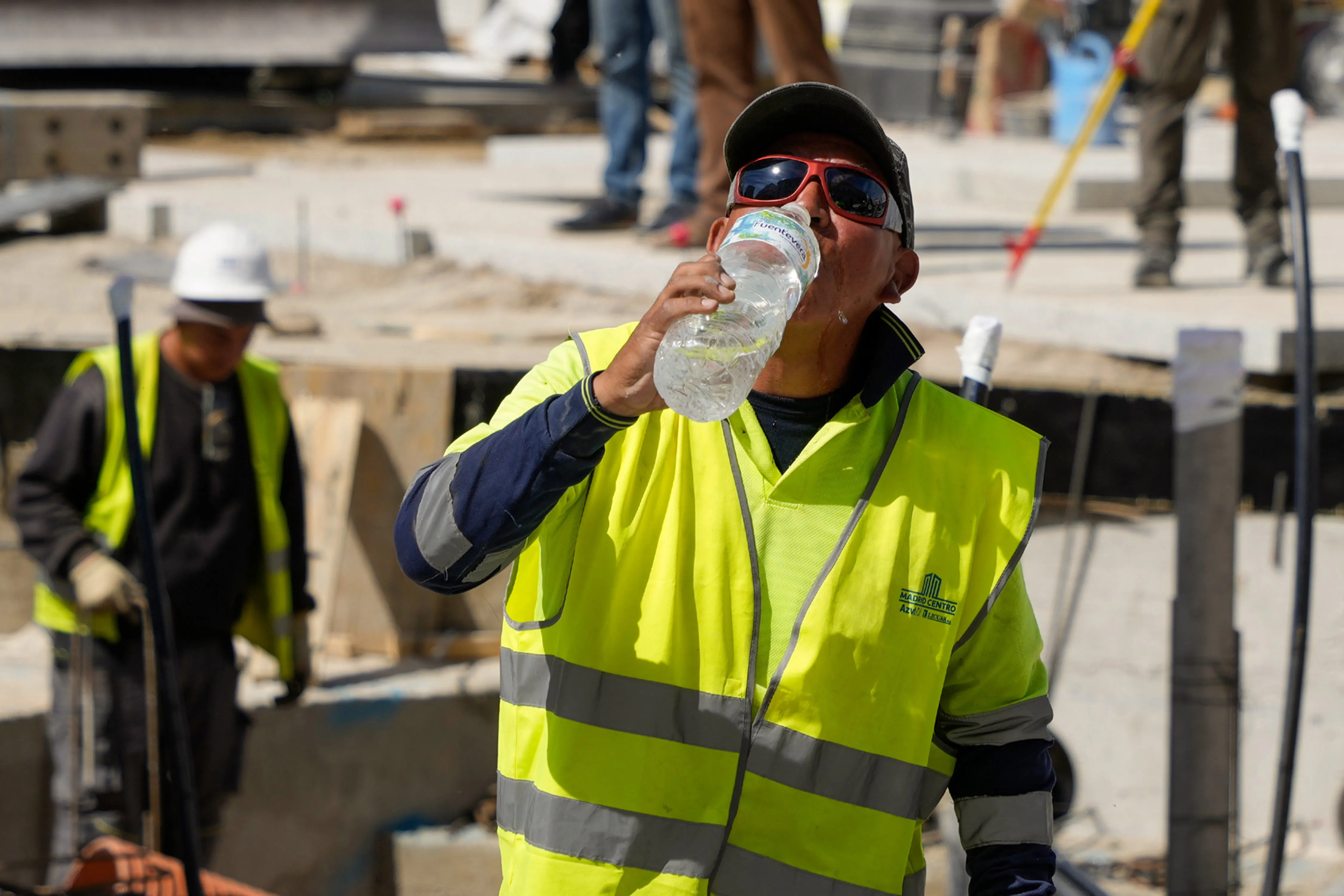 A construction worker rehydrates with water during high temperatures at the Puerta del Sol in Madrid, Spain, on Thursday, April 27, 2023.