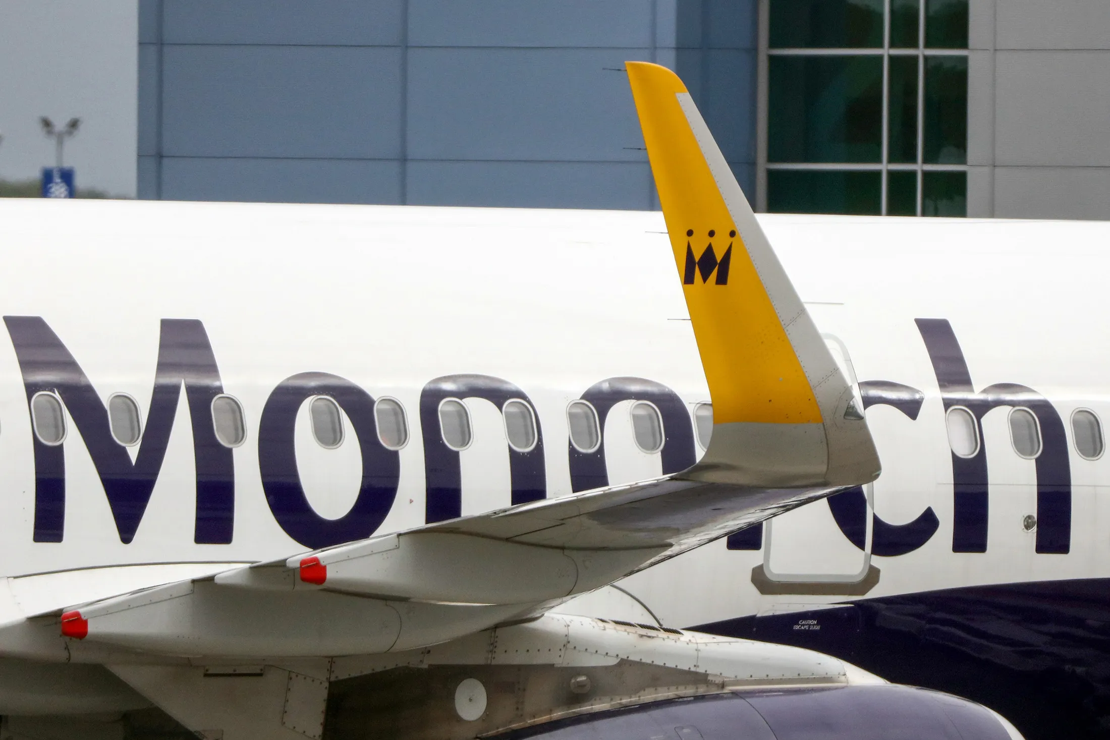 The Monarch Airlines Ltd. logo sits on the fuselage and winglet of an Airbus SAS A320 passenger aircraft at London Luton Airport in Luton, U.K. on Monday, Sept. 26, 2016. Depsite a difficult period in the holiday industry Monarch expects full year Ebitda of more than 40 million pounds and to announce 'significant investment' according to a statement published on the company's website in response to negative speculation about their financial health.
