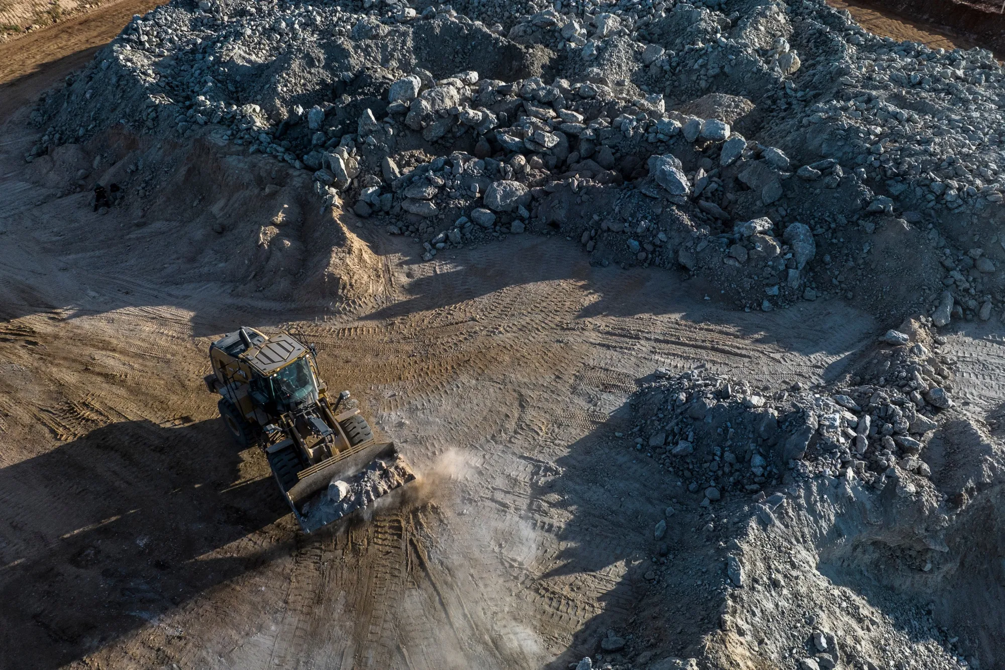 A bulldozer moves lithium ore at a&nbsp;mine.