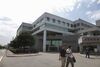 Hon Hai Precision Industry Co. employees walk past the company's headquarters in the Tucheng district of New Taipei, Taiwan, on Wednesday, June 26, 2013.