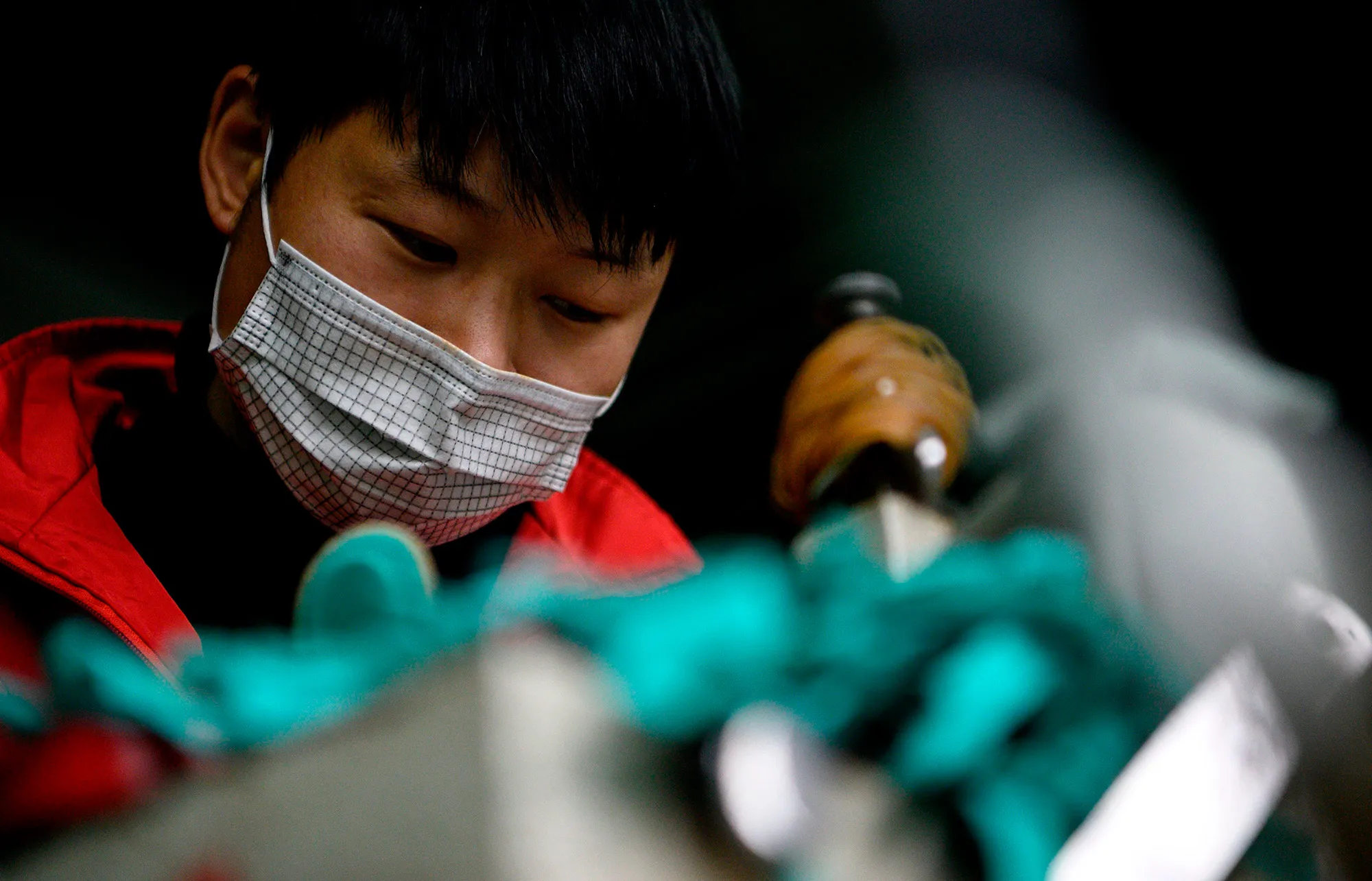 A worker makes insoles at a factory in Wenzhou, China.&nbsp;