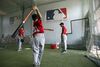 Players take up batting practice at a summer training camp run by Major League Baseball Wuxi, China, in 2010.