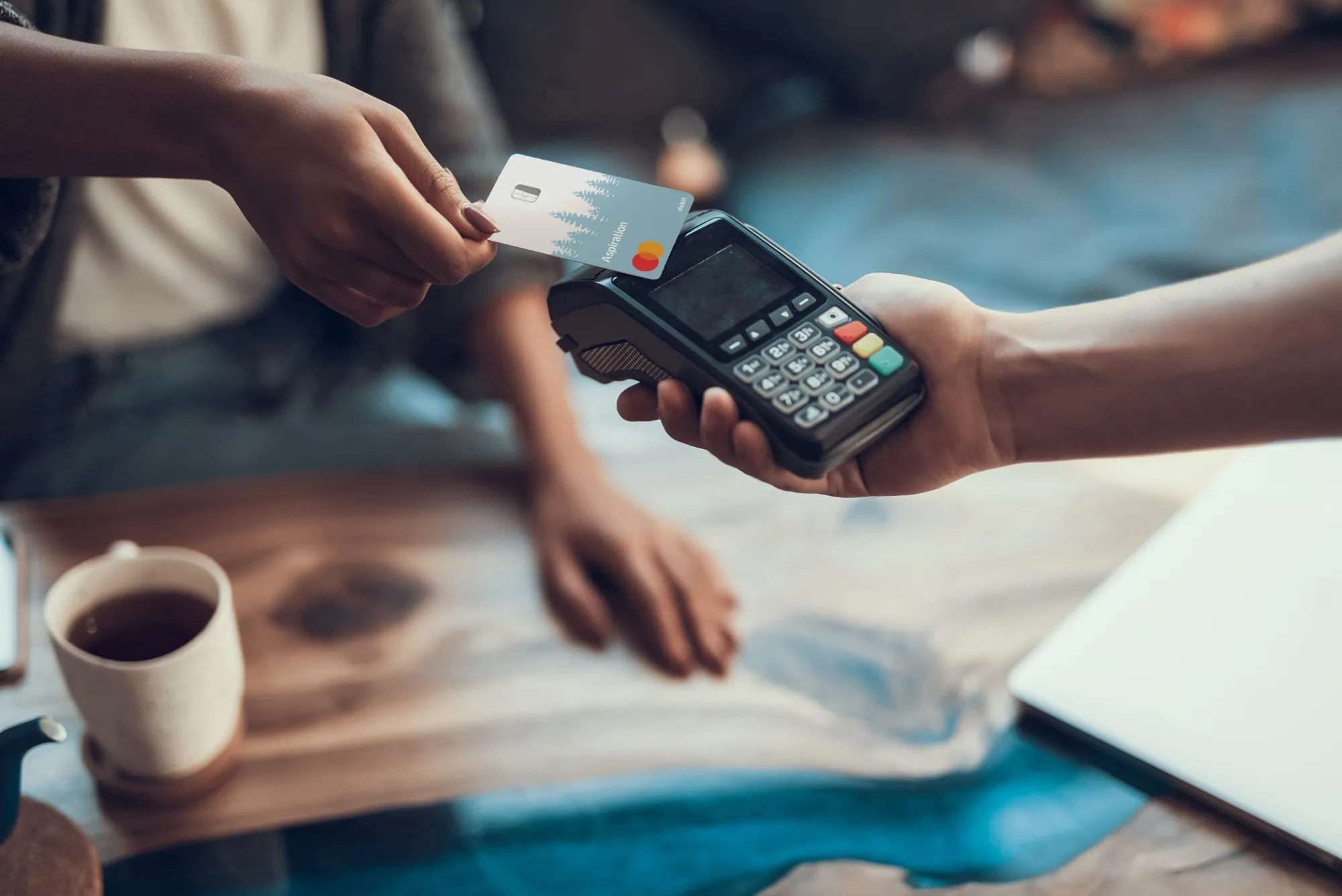 A customer uses an Aspiration card.