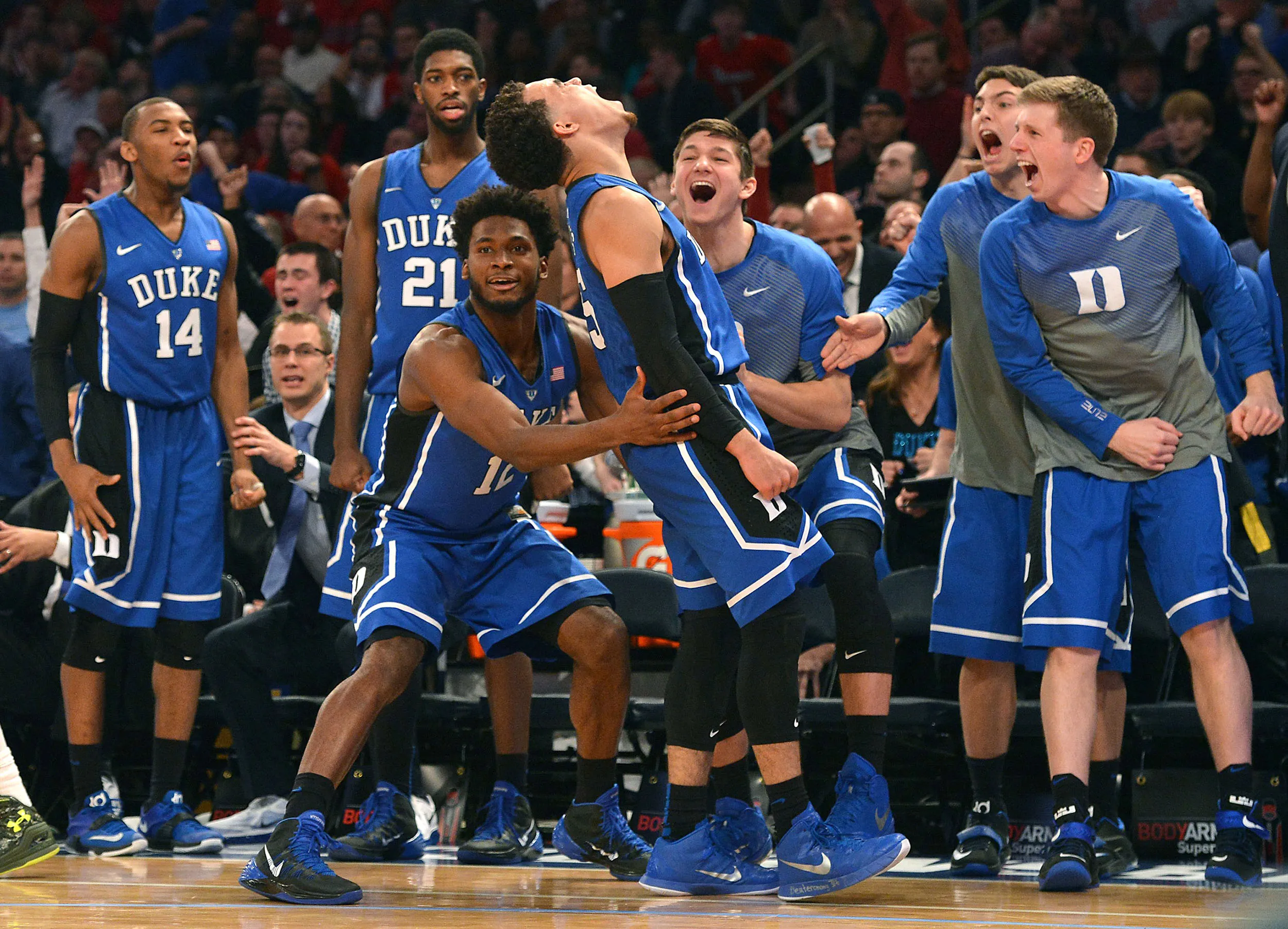 Duke's Tyus Jones (5) reacts as teammate Justise Winslow (12) holds him up after Jones hit a 3-pointer late in the second half and was fouled against St. John's at Madison Square Garden in New York on Jan. 25, 2015.
