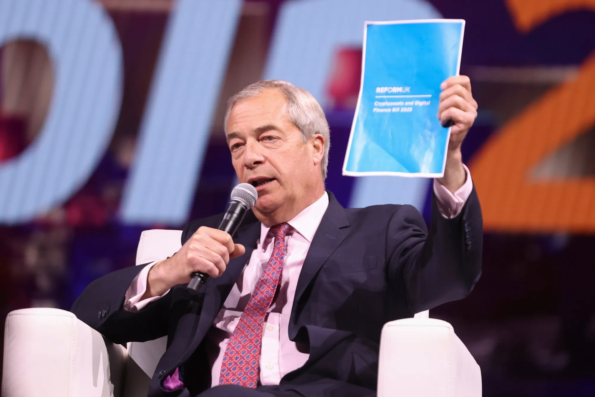 Nigel Farage holds a copy of his proposed Cryptocurrencies and Digital Finance Bill at The Bitcoin Conference in Las Vegas, on May 29.