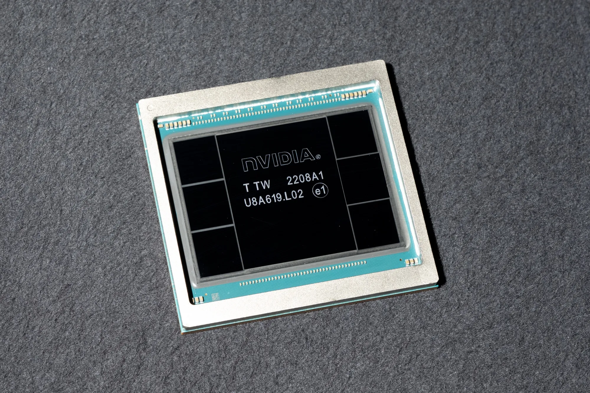 A Nvidia H100 graphics processor chip arranged at the company's headquarters.