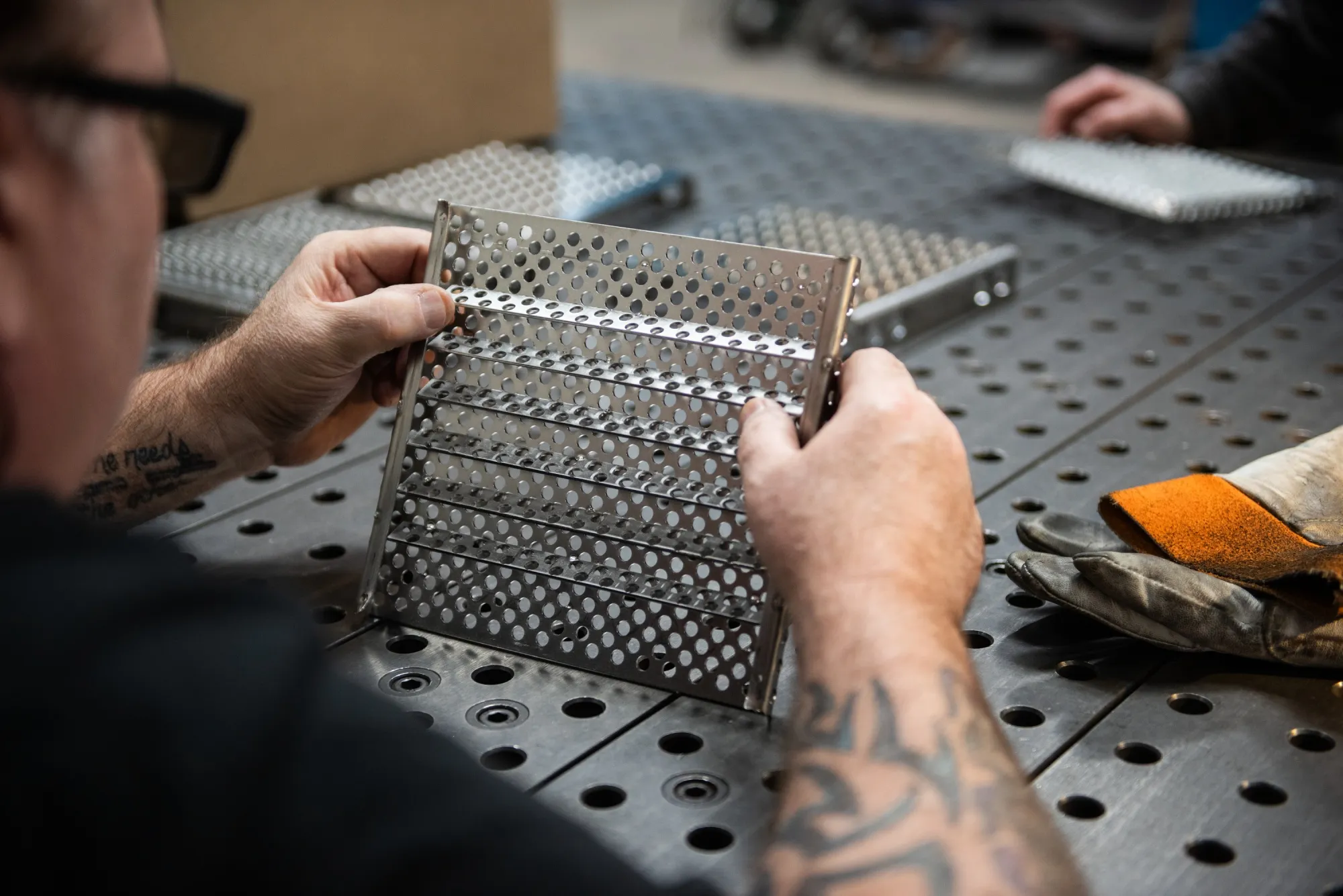 An employee works on a steel fabricated product at the Marlin Steel Wire Products factory in Baltimore.