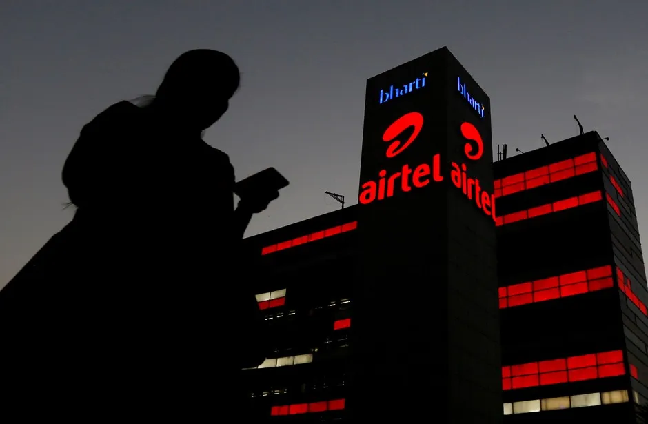 A woman walks by an office building near New Delhi, India.