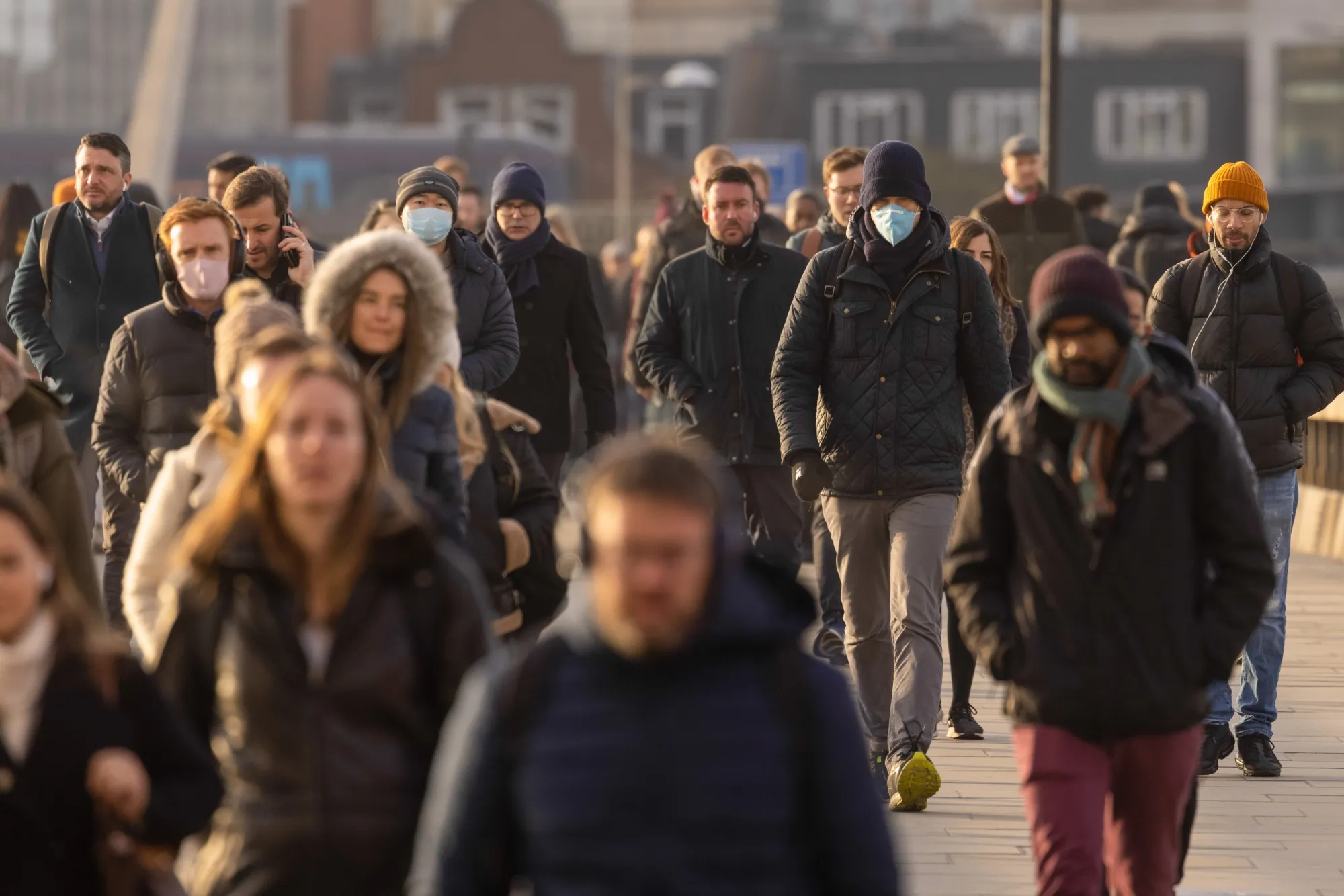 Morning commuters cross London Bridge in London.