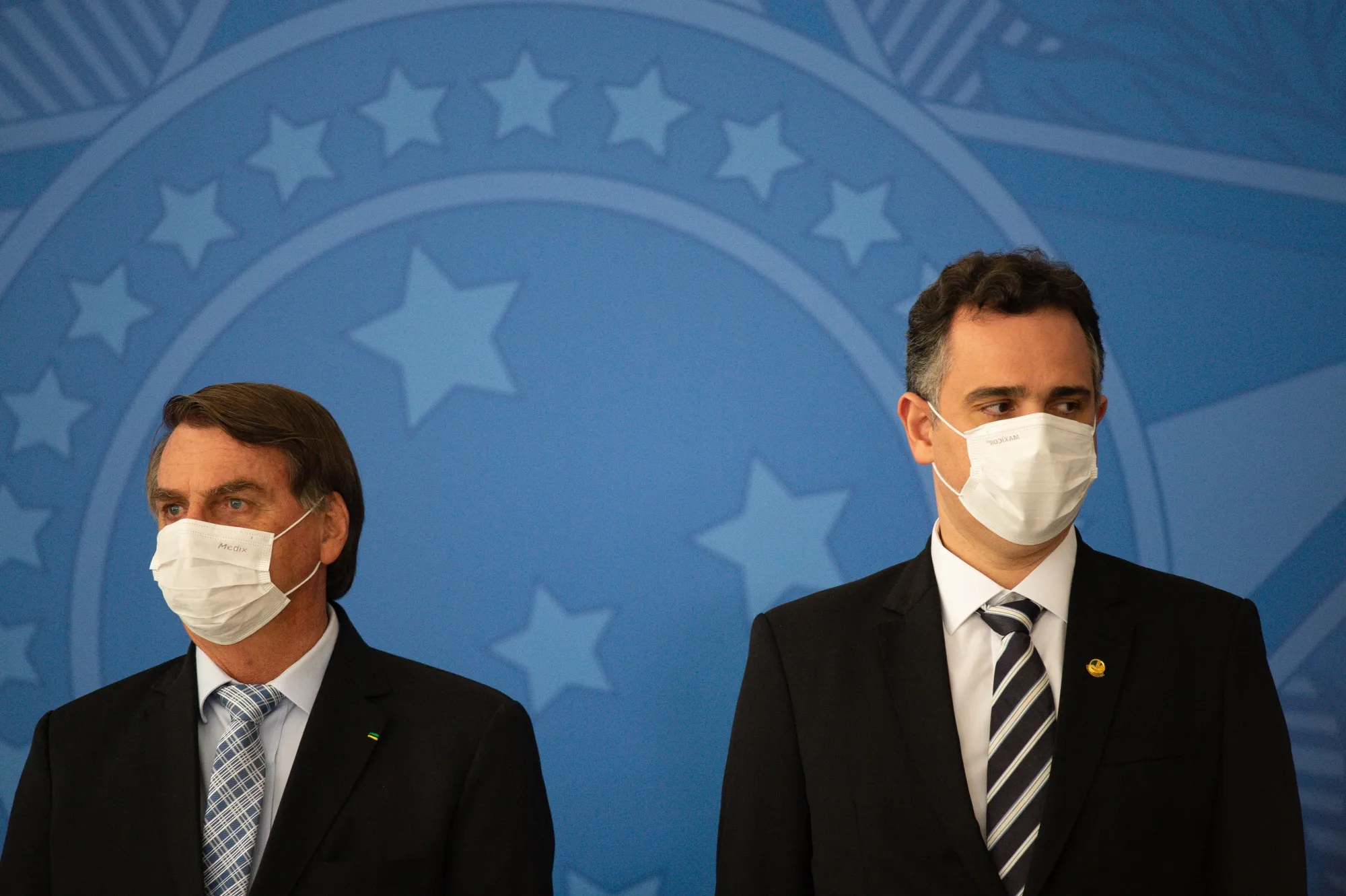 Senate head Rodrigo Pacheco (right), one of the high-ranking members of the new Brazil Union party, stands beside President Jair Bolsonaro