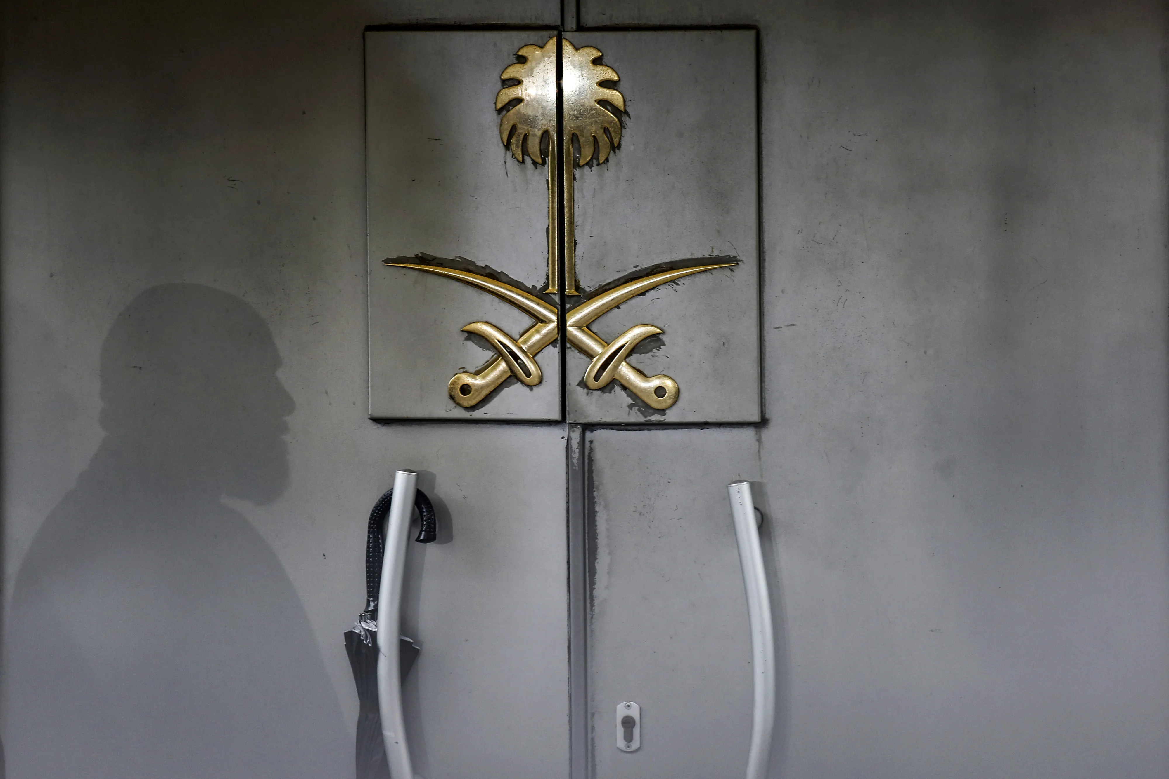 The shadow of a security guard falls on the entrance door of the Saudi Arabian consulate in Istanbul.